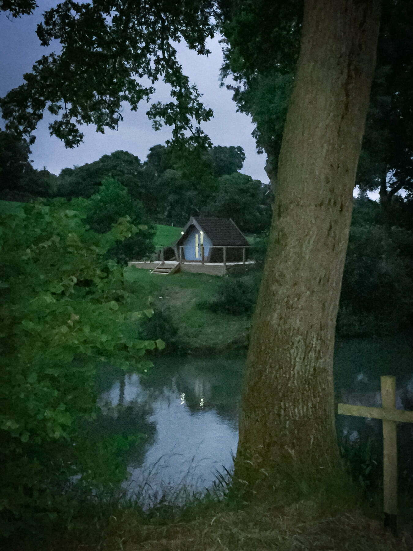 Painswick Glamping – Mill Pool Pod and lake at dusk